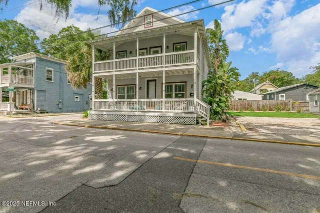 a front view of a building with a garden