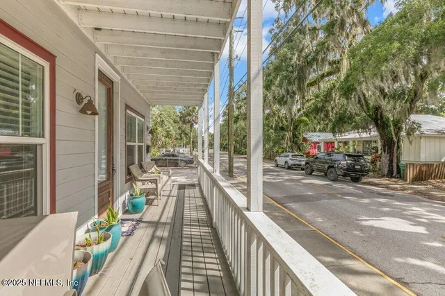 a view of balcony with wooden floor and outdoor seating