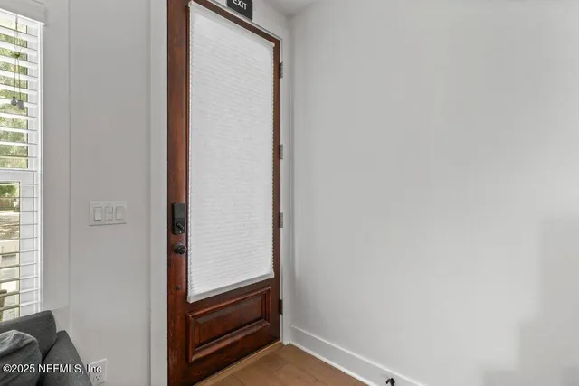 a living room with furniture a couch and a window