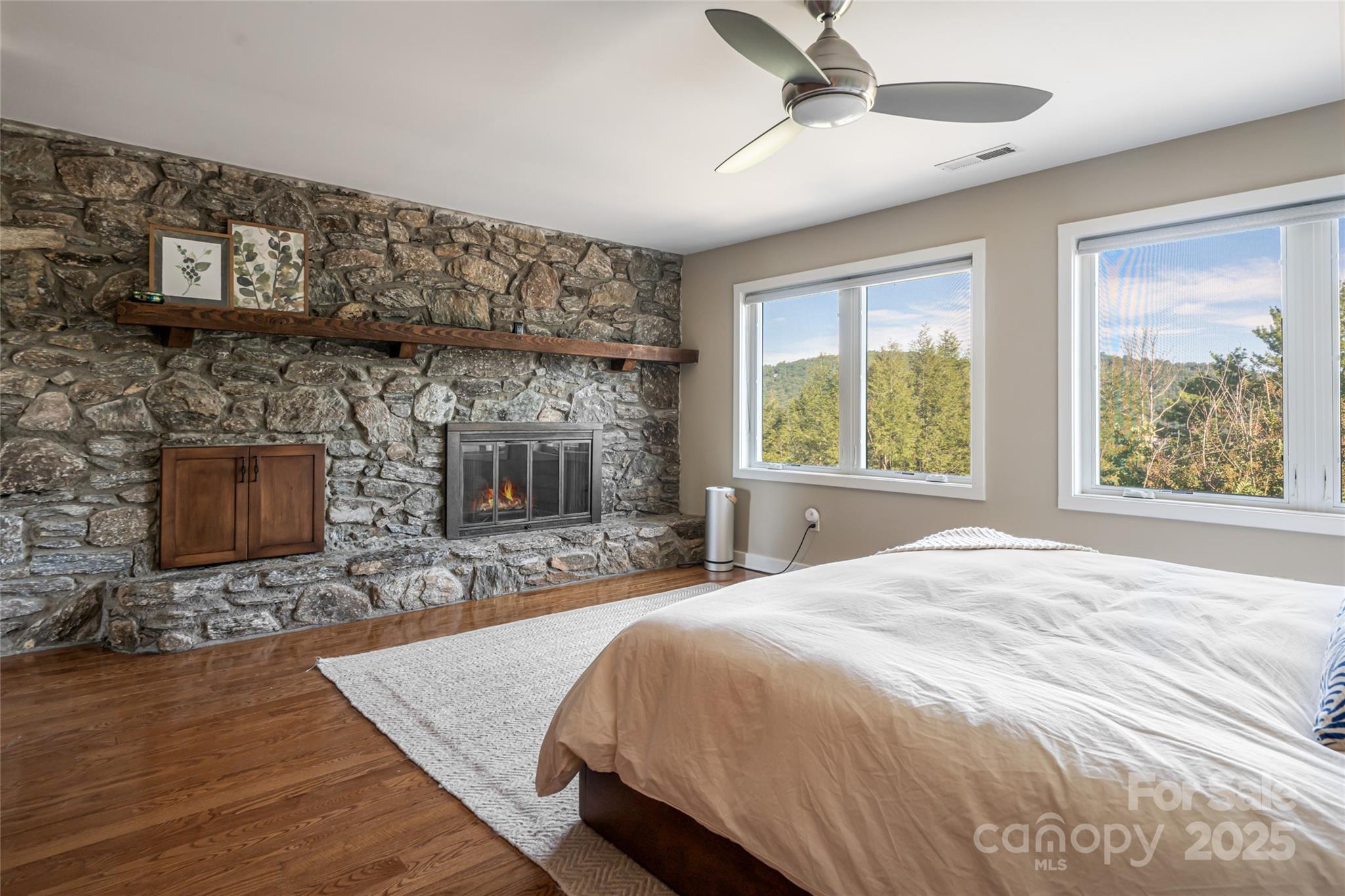 79 Horizon Hill Road Asheville, NC 28804 - Photo 24 of 48 a spacious bedroom with a bed and a fireplace