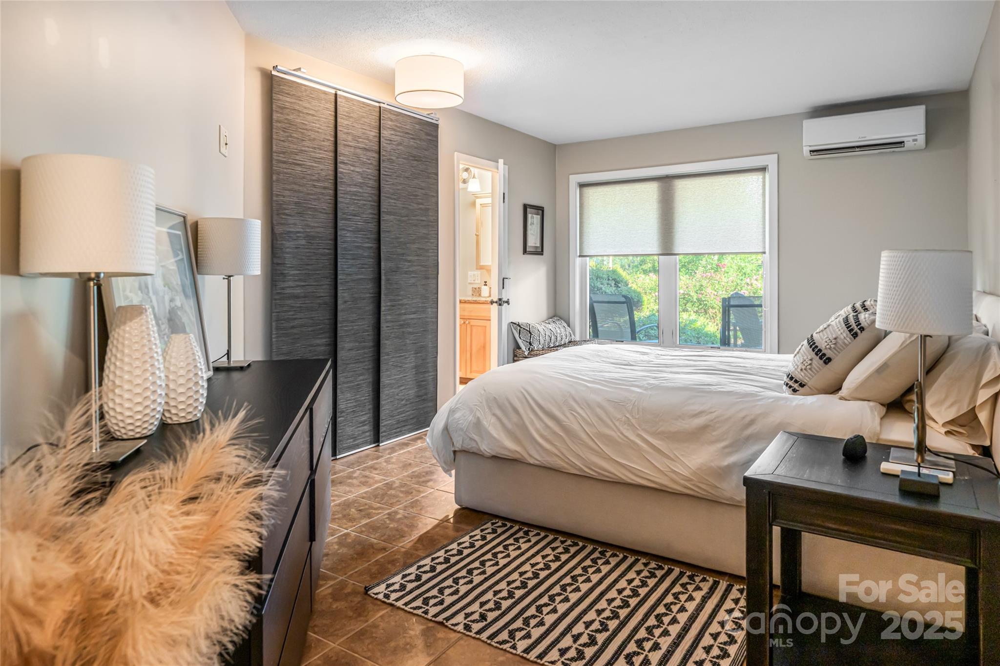 79 Horizon Hill Road Asheville, NC 28804 - Photo 33 of 48 a bedroom with a bed and wooden floor