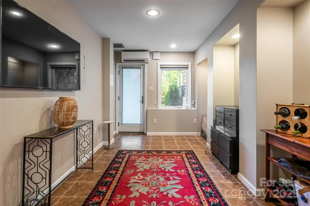 a living room filled with furniture and a floor to ceiling window