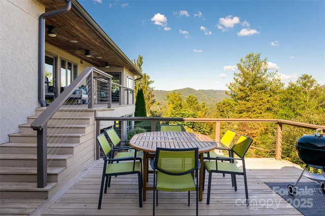 a balcony view with couple of chairs and wooden floor