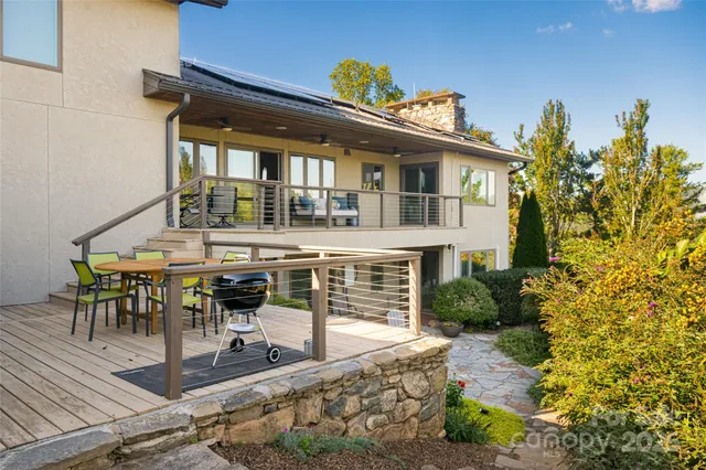 a view of a house with backyard sitting area and garden