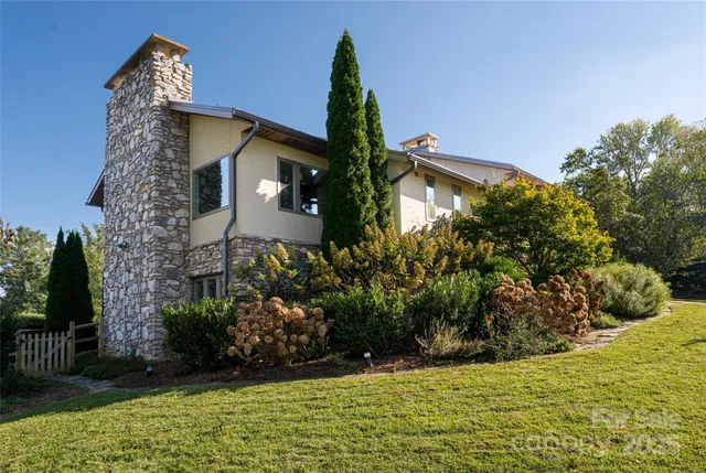a front view of a house with a yard and plants