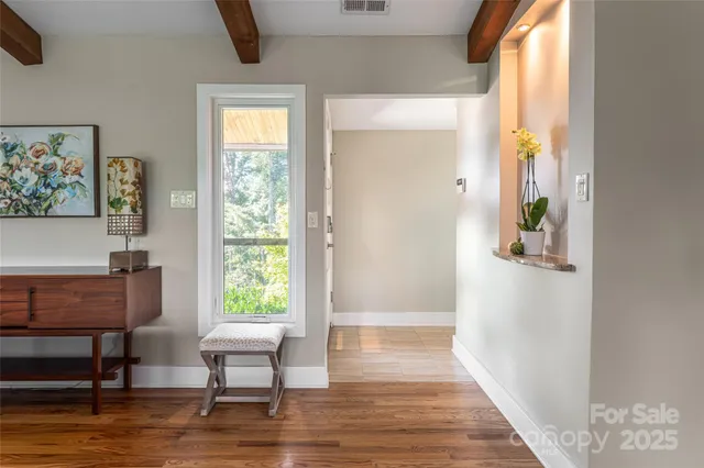 a view of a livingroom with furniture window and wooden floor