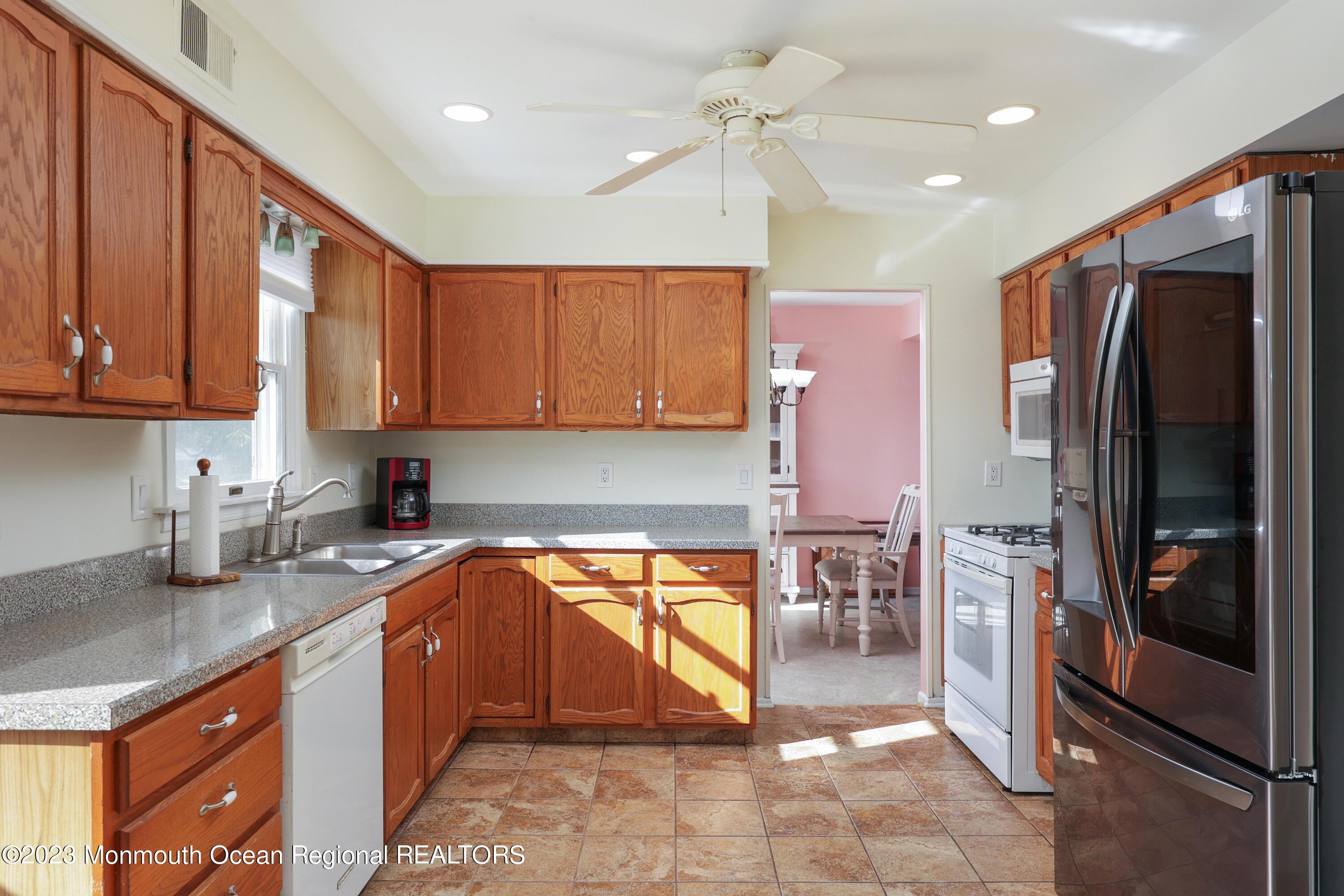 146 Jordan Road Brick, NJ 08724 - Photo 12 of 36 a kitchen with a refrigerator a sink and cabinets