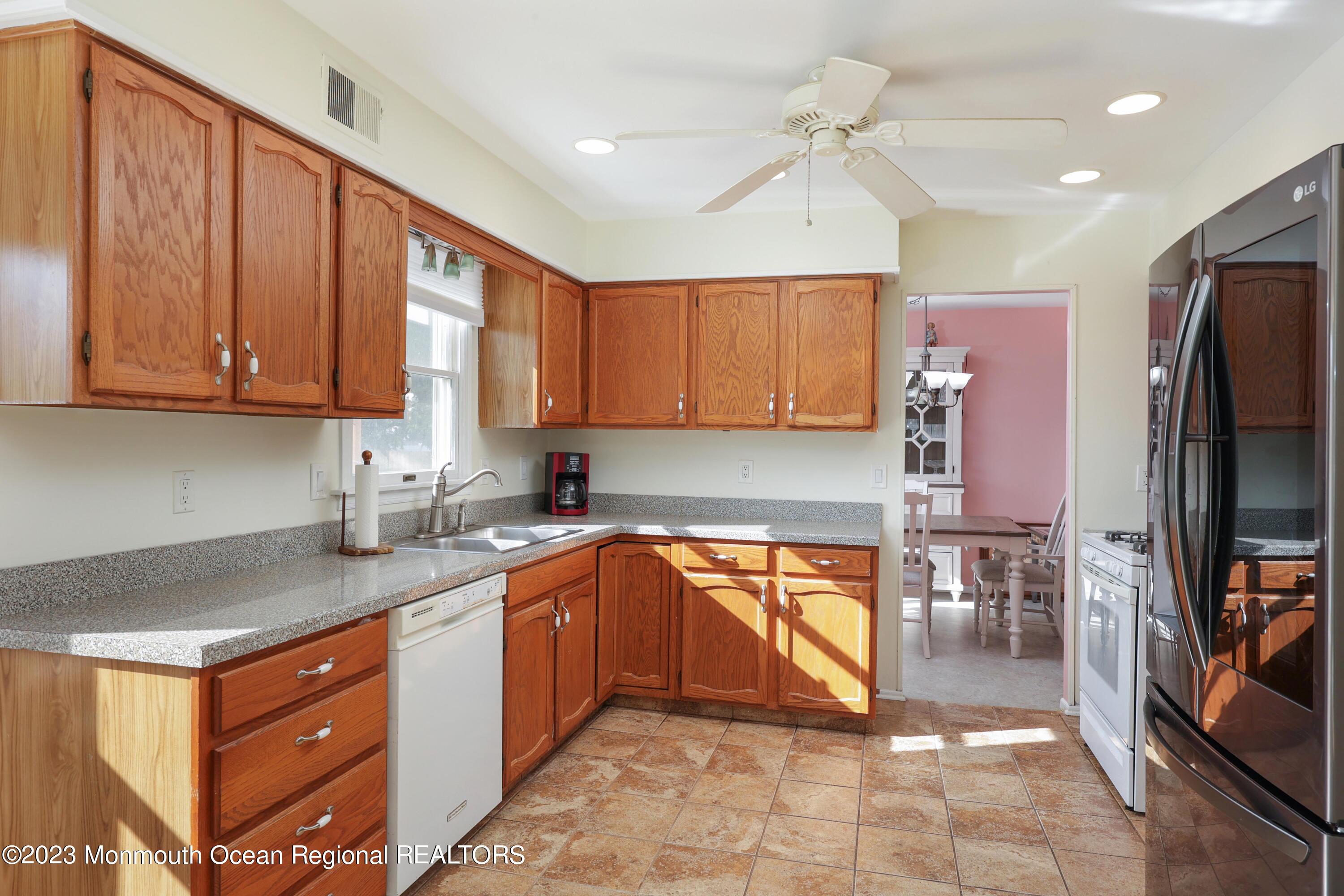 146 Jordan Road Brick, NJ 08724 - Photo 14 of 36 a kitchen with stainless steel appliances granite countertop a sink stove and refrigerator