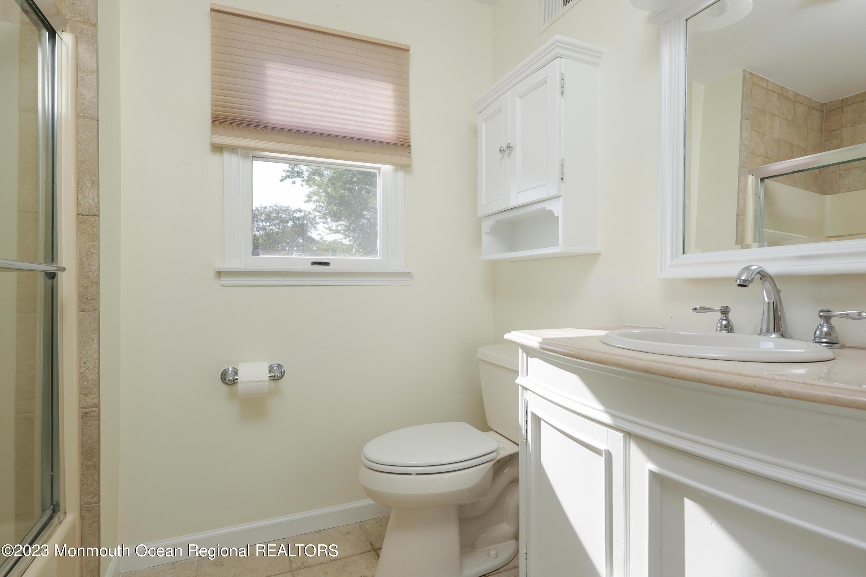 146 Jordan Road Brick, NJ 08724 - Photo 23 of 36 a bathroom with a toilet a sink and mirror