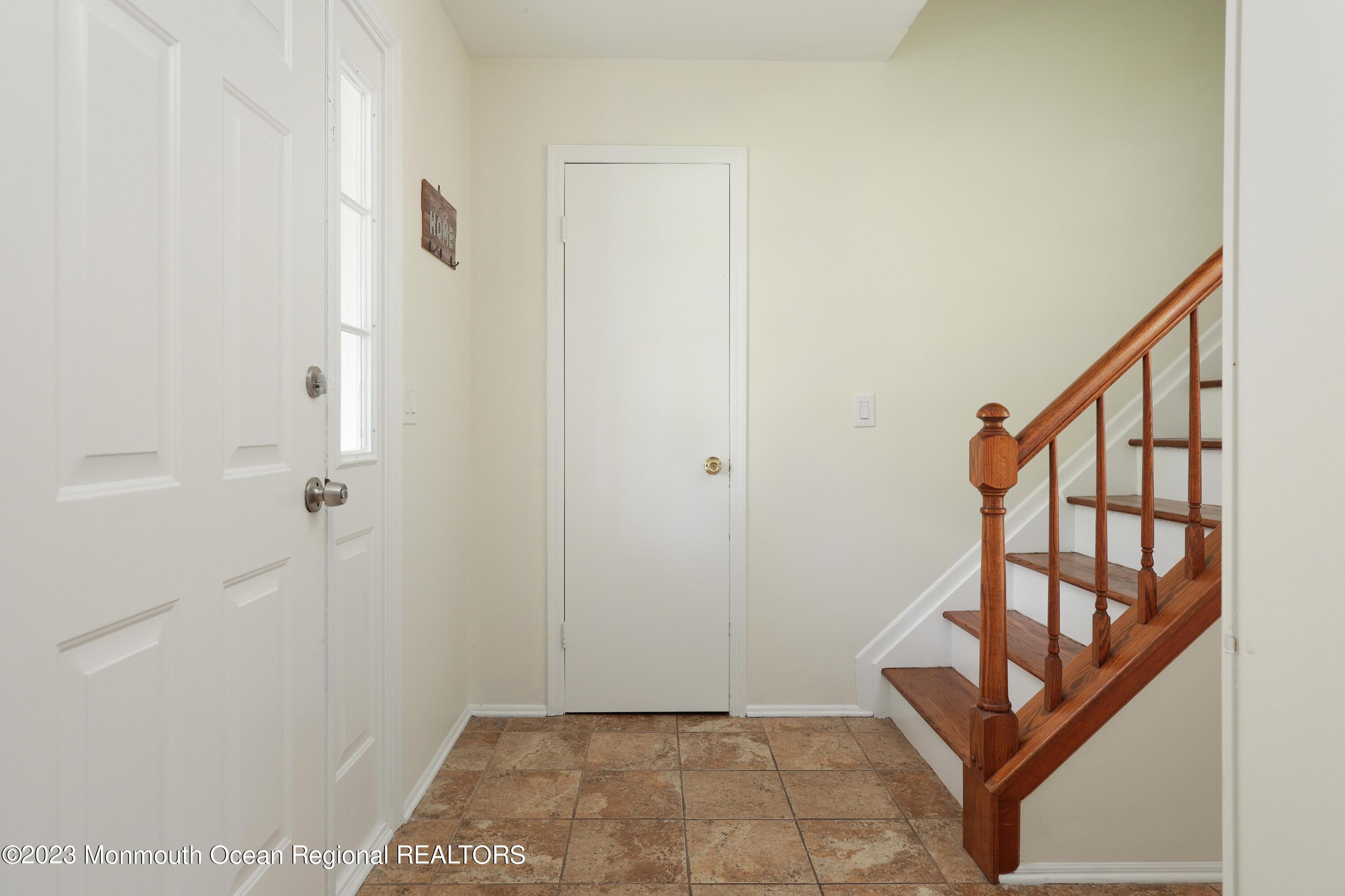 146 Jordan Road Brick, NJ 08724 - Photo 8 of 36 a view of a hallway with wooden floor and stairs