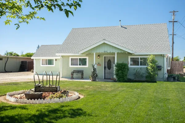 a front view of a house with a garden
