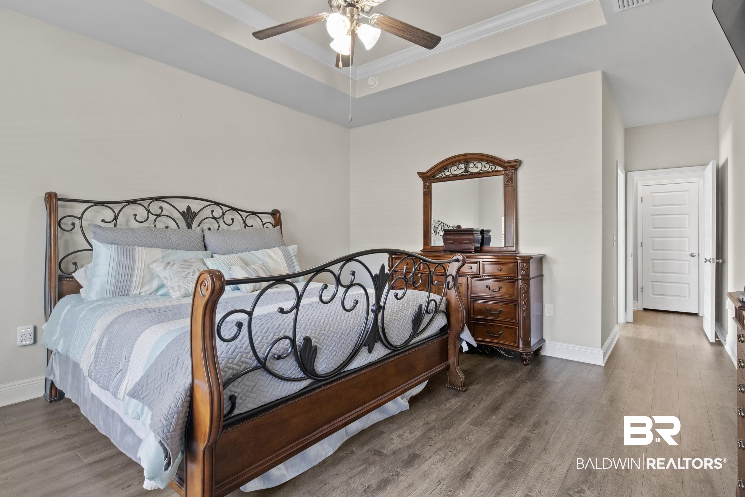 2050 Bourbon Street Foley, AL 36535 - Photo 17 of 32 Bedroom featuring hardwood / wood-style floors, a tray ceiling, ceiling fan, and ornamental molding