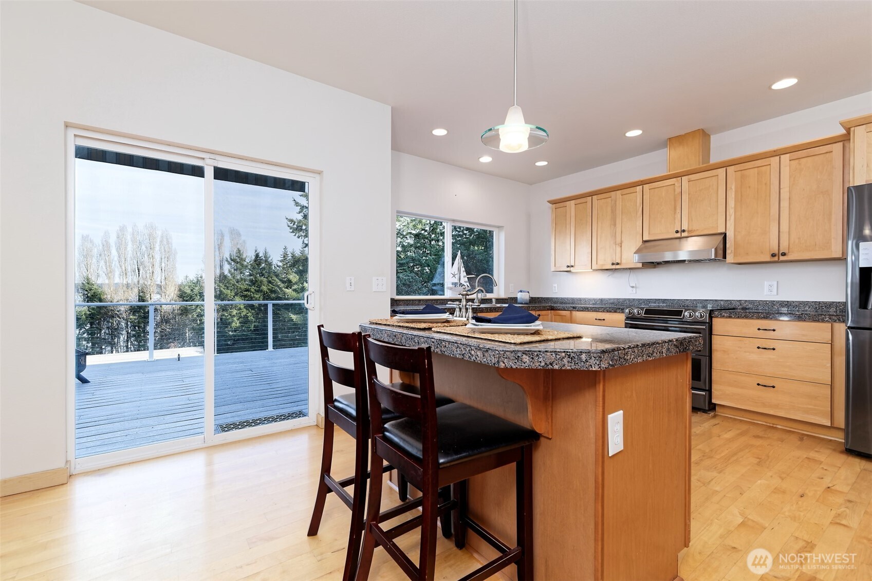 20 East Case View Place Shelton, WA 98584 - Photo 10 of 40 a kitchen with a stove a sink a refrigerator and a dining table