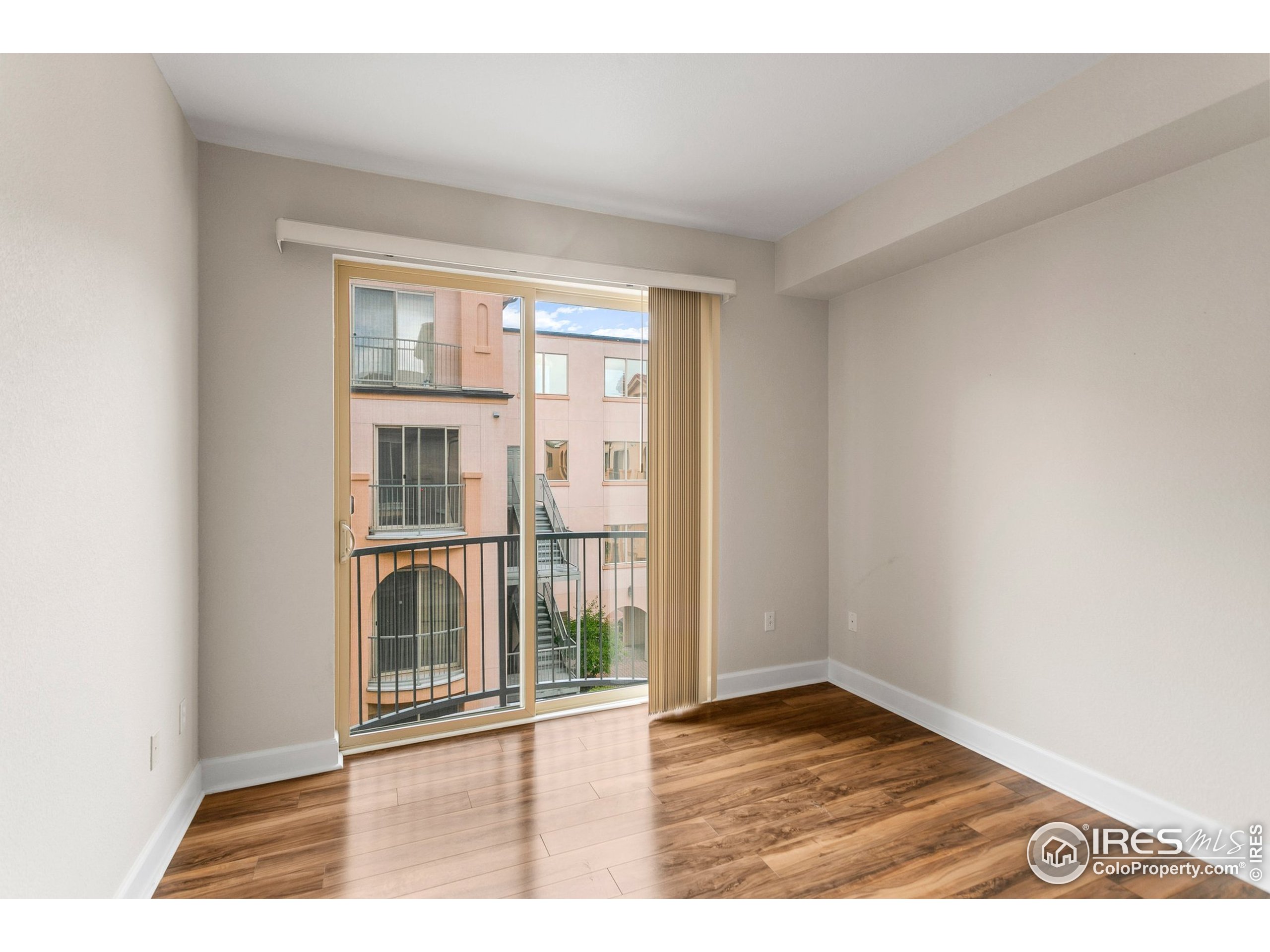 4500 Baseline Road, Unit 3302 Boulder, CO 80303 - Photo 22 of 22 an empty room with wooden floor and windows