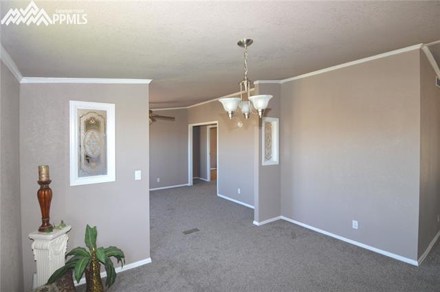 27055 Handle Road Calhan, CO 80808 - Photo 17 of 25 Another view looking into the family room. The hallway on the right is where the 3 other bedrooms and full bath are located.