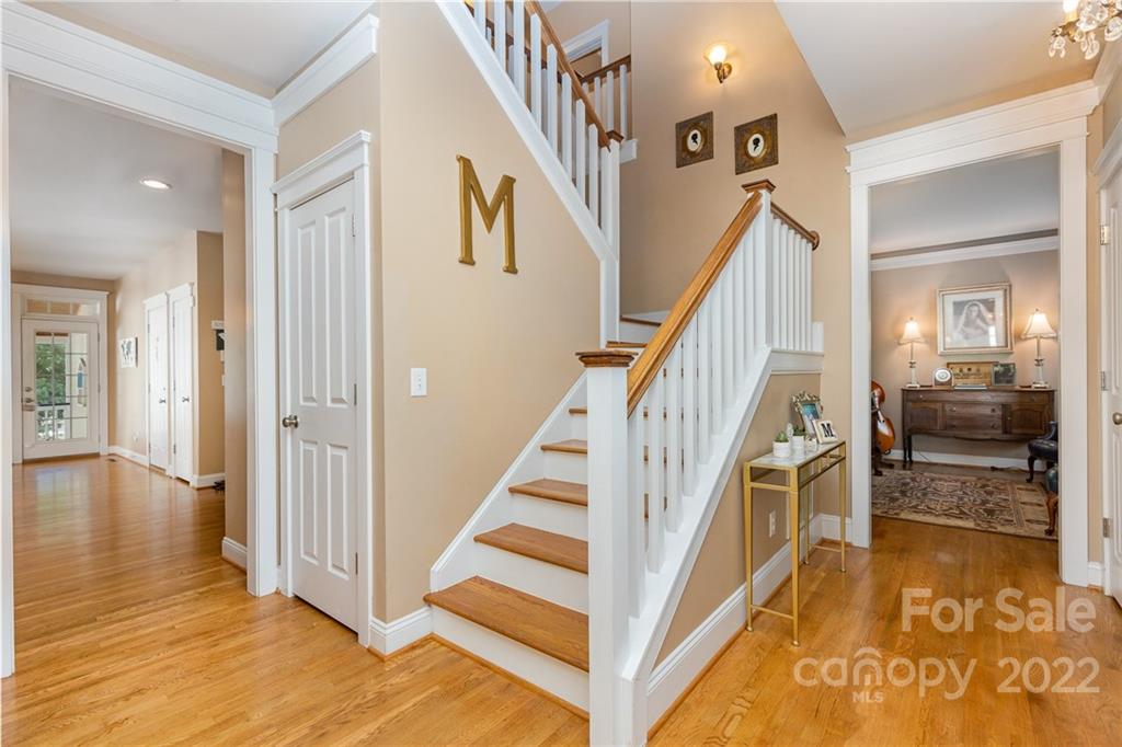 919 Cara Court Fort Mill, SC 29708 - Photo 4 of 35 a view of a hallway with wooden floor and staircase