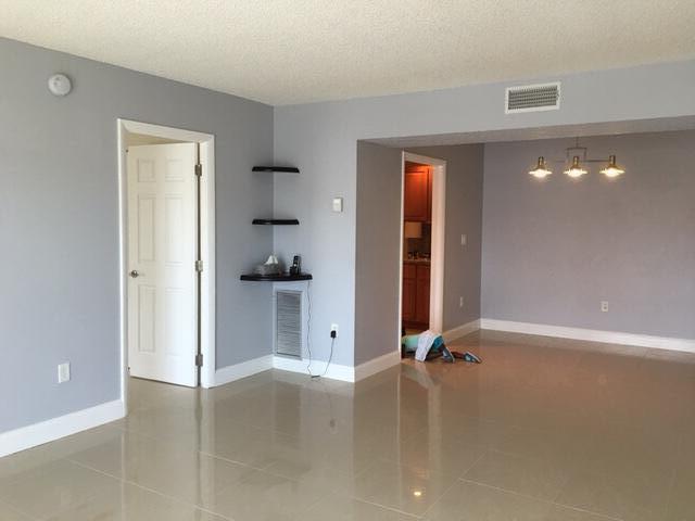 4154 Inverrary Drive, Unit 407 Lauderhill, FL 33319 - Photo 2 of 39 an empty room with closet and windows