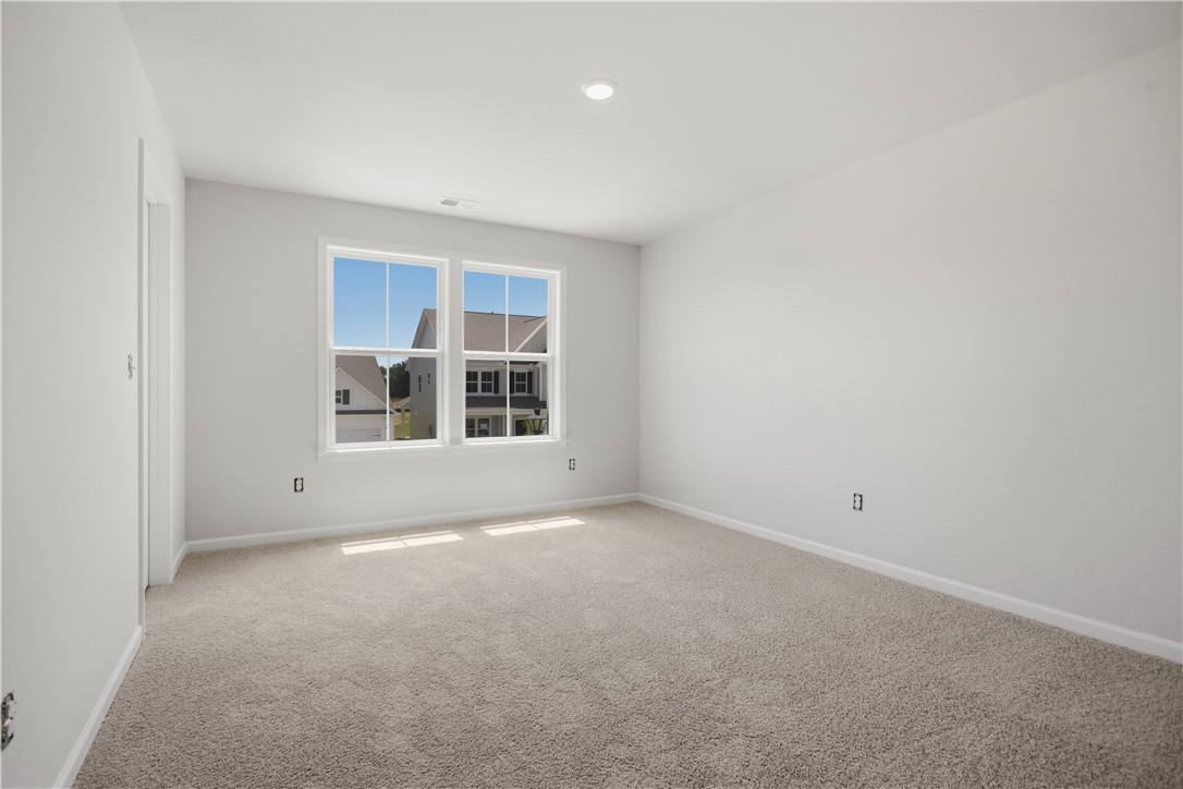 552 Hydrangea Street, Unit LOT 66 Seneca, SC 29678 - Photo 26 of 31 A quiet bedroom featuring plush carpeting and a pair of sun-filled windows.