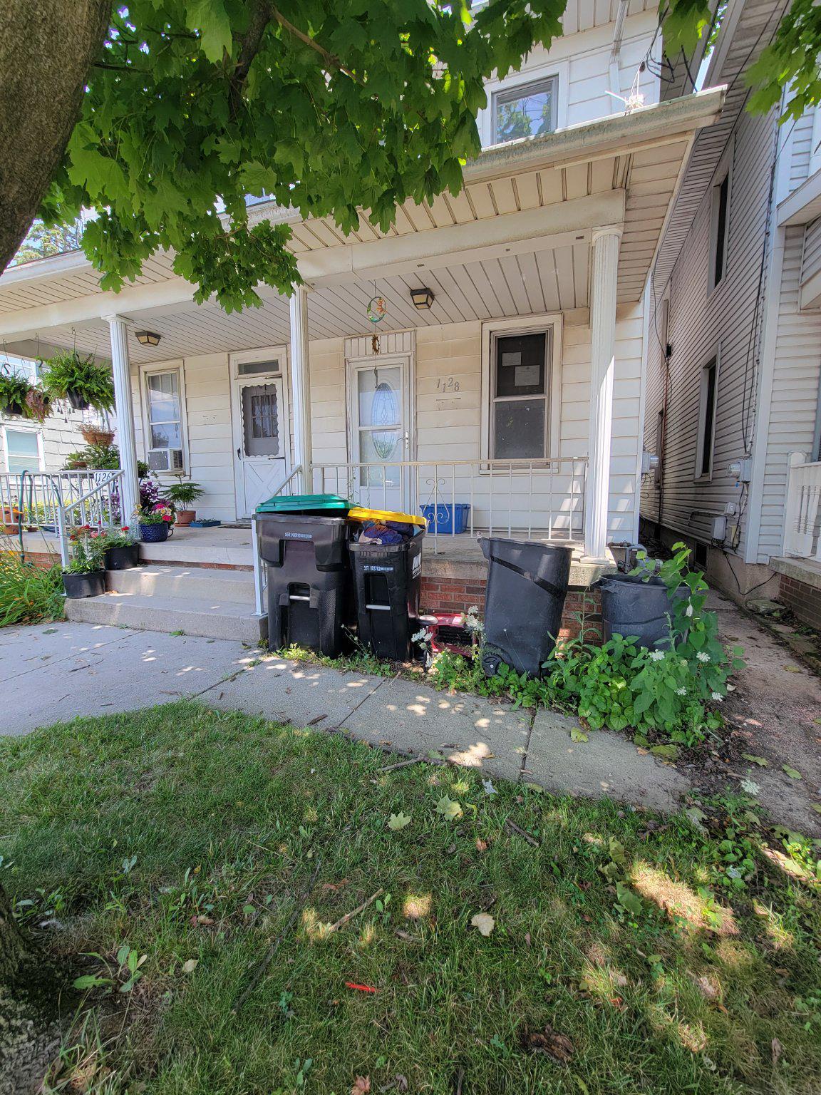 1128 Baltimore Street Hanover, PA 17331 - Photo 1 of 16 Charming porch with vibrant greenery.