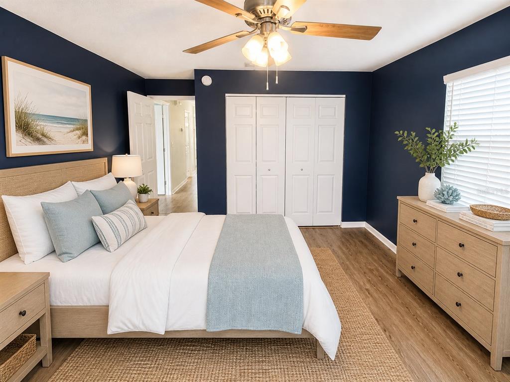1013 Apollo Beach Boulevard, Unit 202 Apollo Beach, FL 33572 - Photo 14 of 18 a bedroom with a large bed and a chandelier