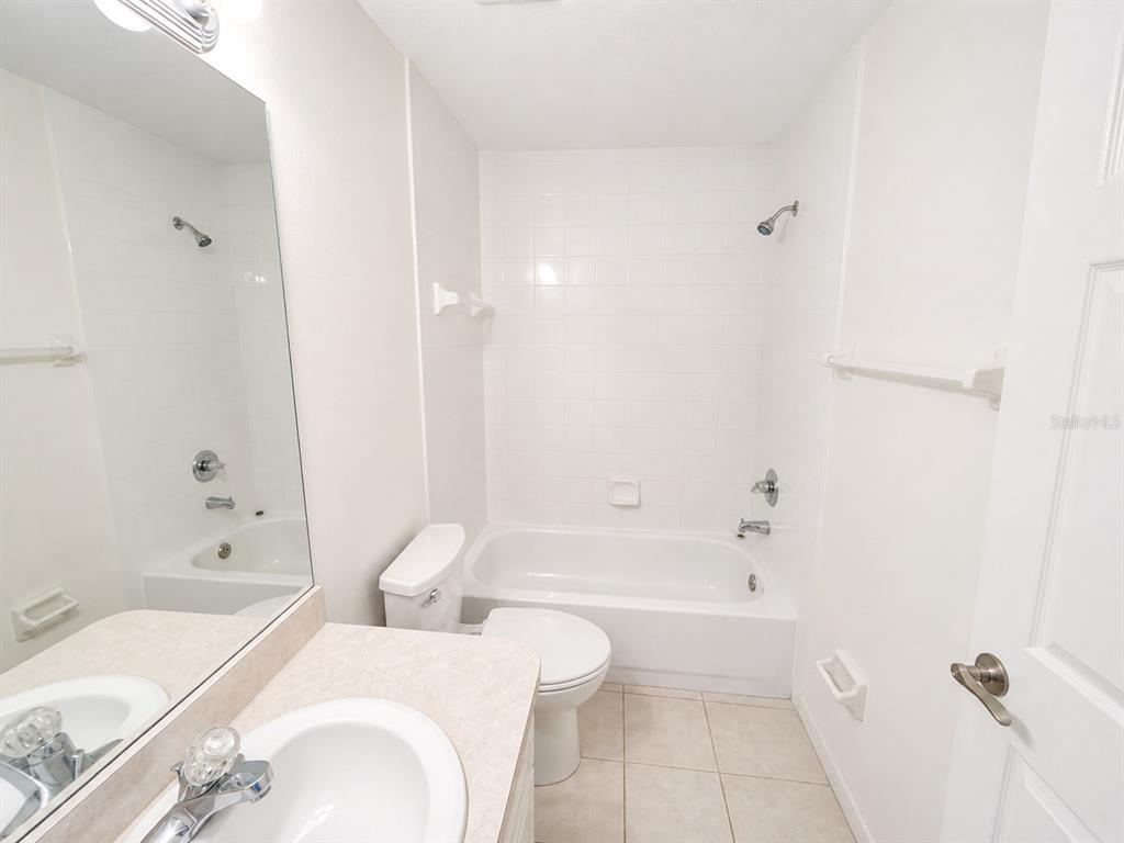 1013 Apollo Beach Boulevard, Unit 202 Apollo Beach, FL 33572 - Photo 15 of 18 a bathroom with a bathtub shower sink and toilet