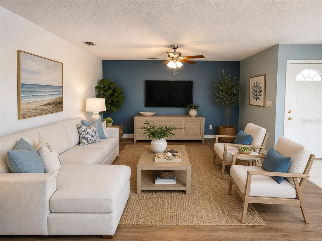 1013 Apollo Beach Boulevard, Unit 202 Apollo Beach, FL 33572 - Photo 3 of 18 a living room with furniture and a flat screen tv