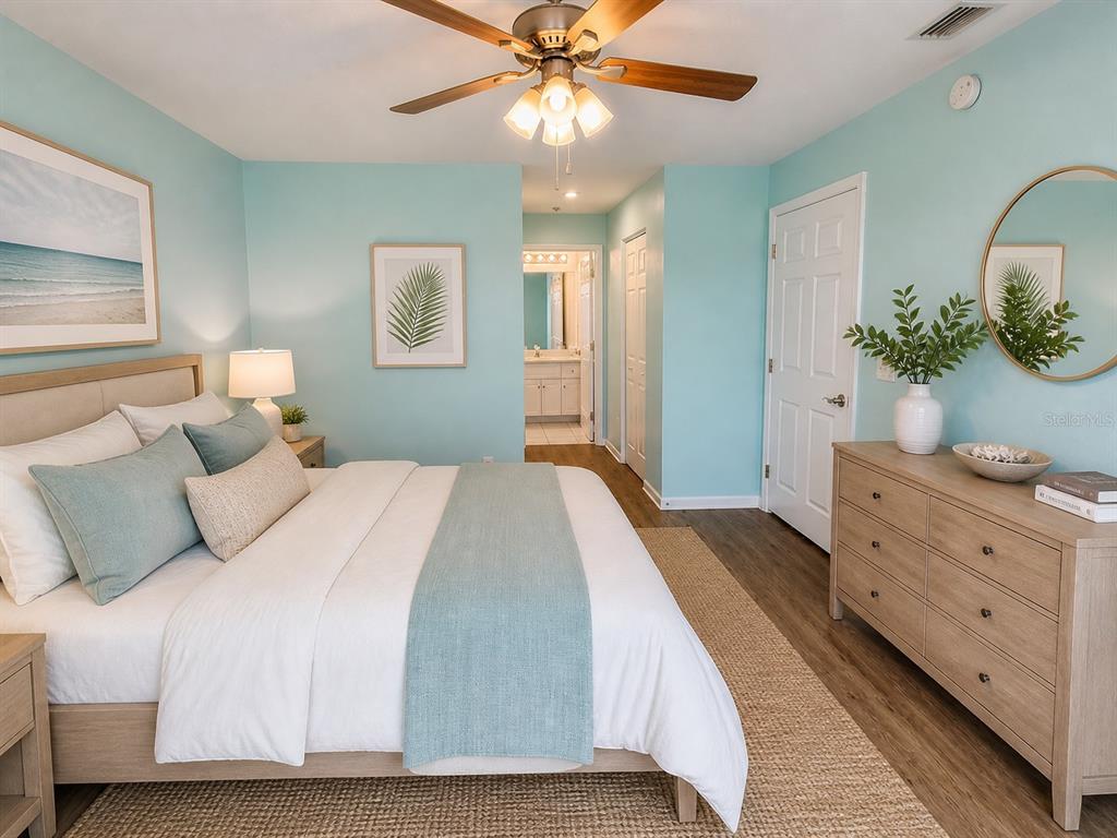1013 Apollo Beach Boulevard, Unit 202 Apollo Beach, FL 33572 - Photo 8 of 18 a bedroom with a large bed and a chandelier fan