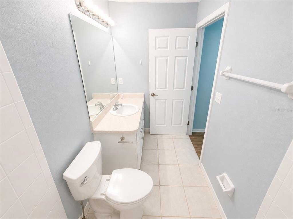1013 Apollo Beach Boulevard, Unit 202 Apollo Beach, FL 33572 - Photo 9 of 18 a bathroom with a toilet and a mirror
