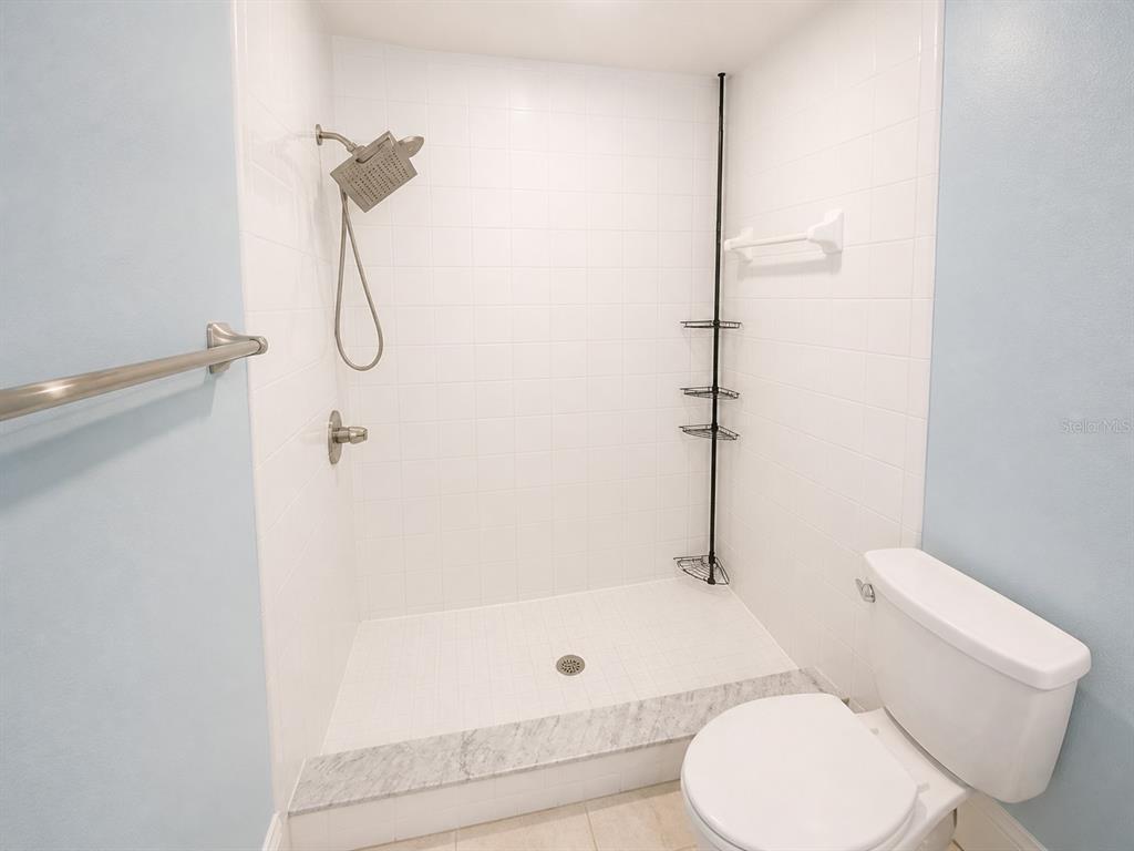 1013 Apollo Beach Boulevard, Unit 202 Apollo Beach, FL 33572 - Photo 10 of 18 a bathroom with a toilet and a shower