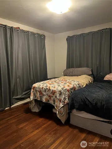 a bedroom with a bed and a curtain