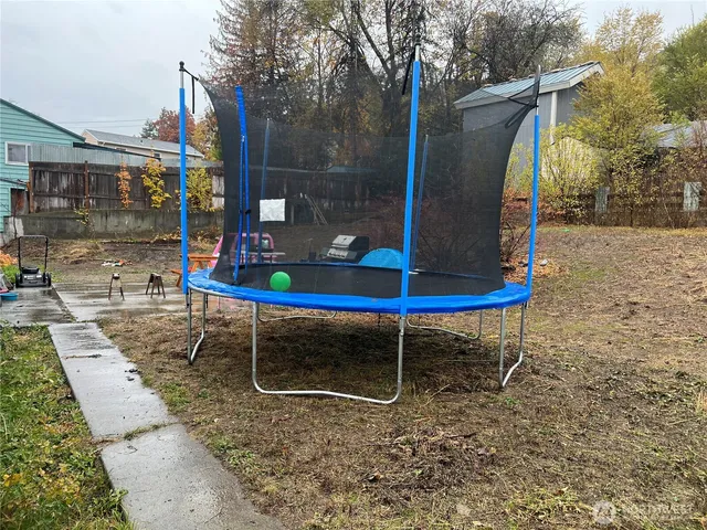 a backyard of a house with table and chairs