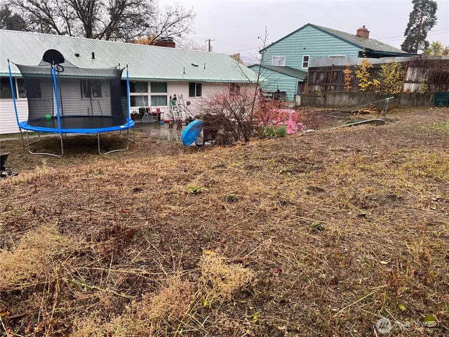 a view of a house with a backyard and a patio