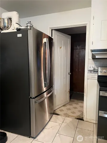 a kitchen with stainless steel appliances granite countertop a refrigerator and a stove