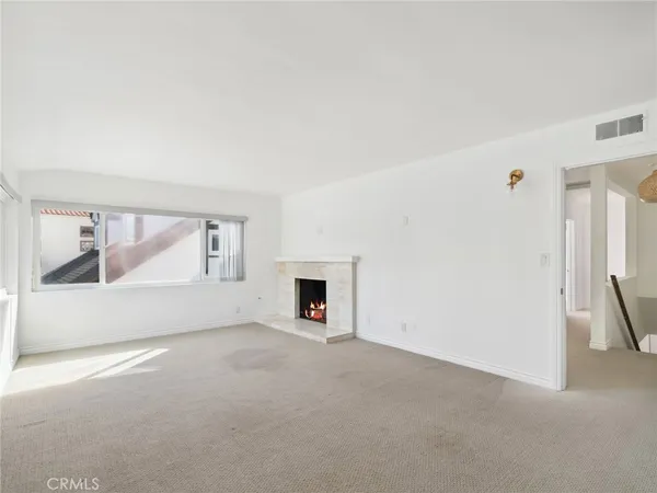 a view of empty room with a fireplace
