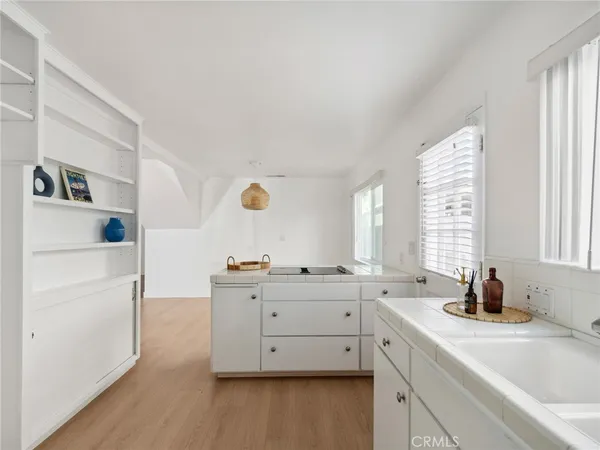 a kitchen with a sink cabinets appliances and a window
