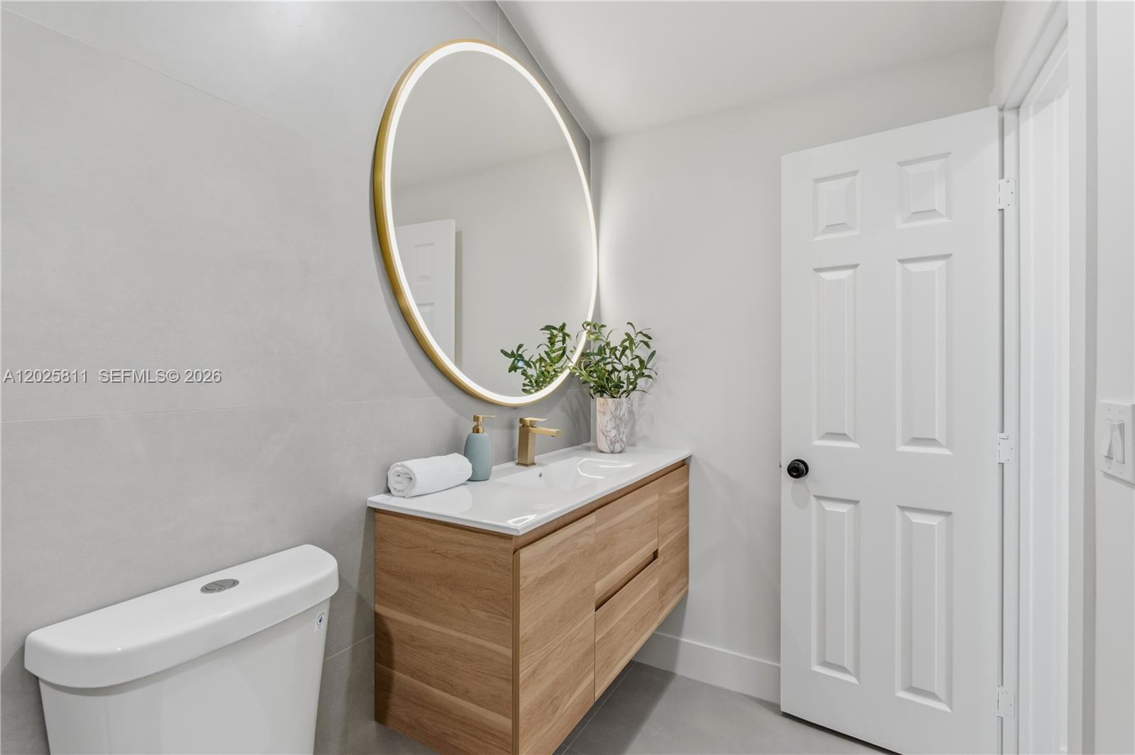 2110 Southwest 15th Street Miami, FL 33145 - Photo 30 of 37 a bathroom with a sink a toilet and a mirror