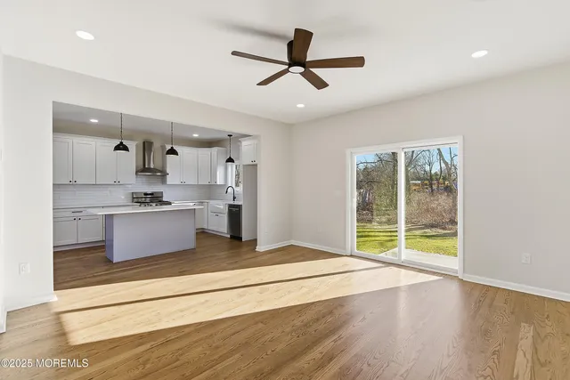 a kitchen with white cabinets and sink