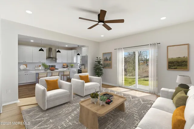 a open kitchen with stainless steel appliances granite countertop a stove and white cabinets