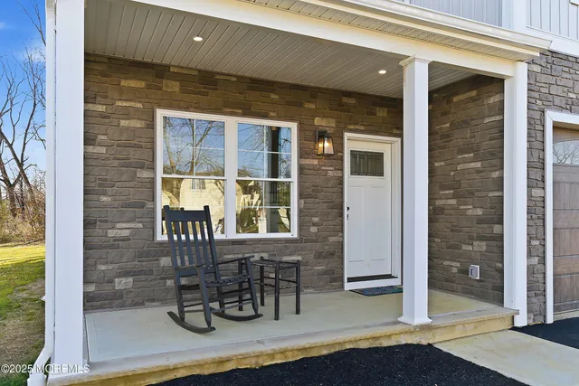 a glass door and chair table and front door of house