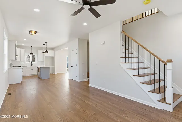a living room with lots of furniture and a view of kitchen