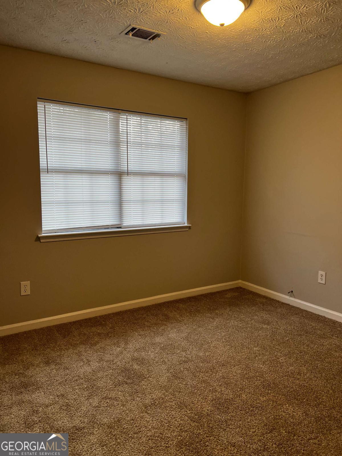 164 Adrian Drive Stockbridge, GA 30281 - Photo 11 of 12 an empty room with a window