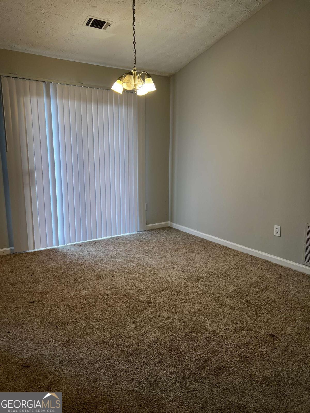 164 Adrian Drive Stockbridge, GA 30281 - Photo 3 of 12 an empty room with chandelier fan