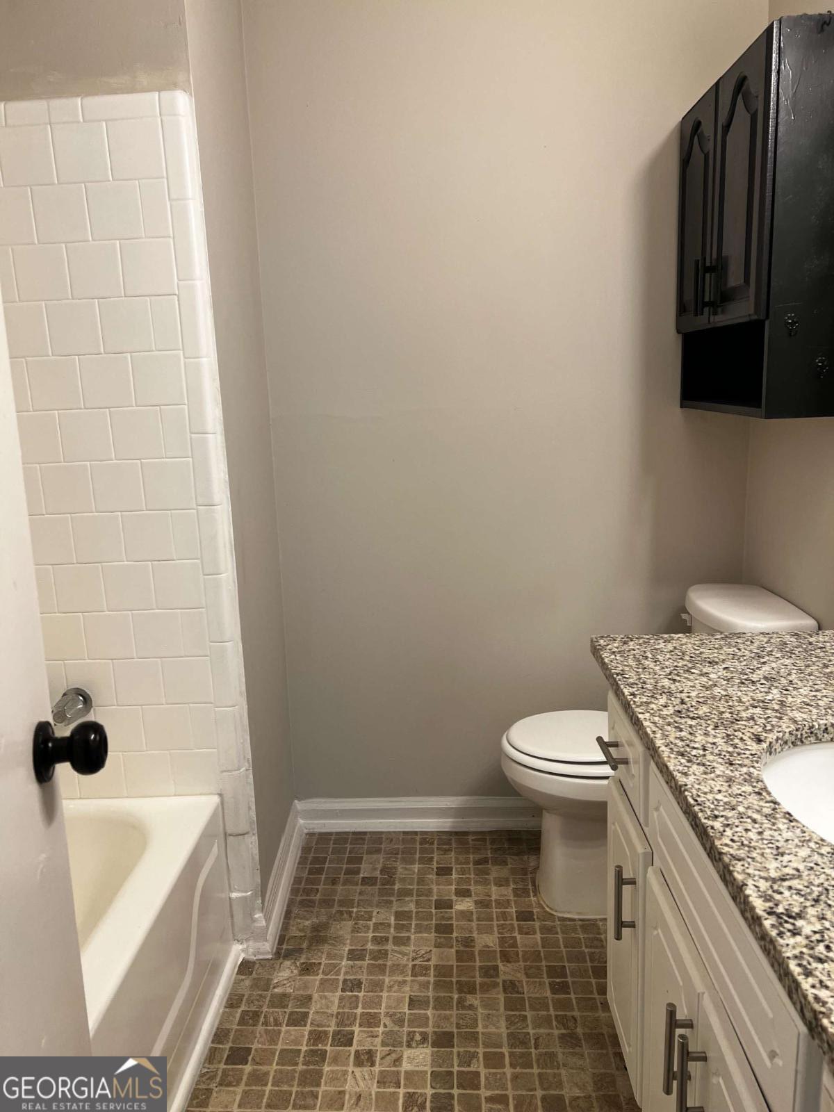 164 Adrian Drive Stockbridge, GA 30281 - Photo 8 of 12 a bathroom with a granite countertop toilet and a bathtub