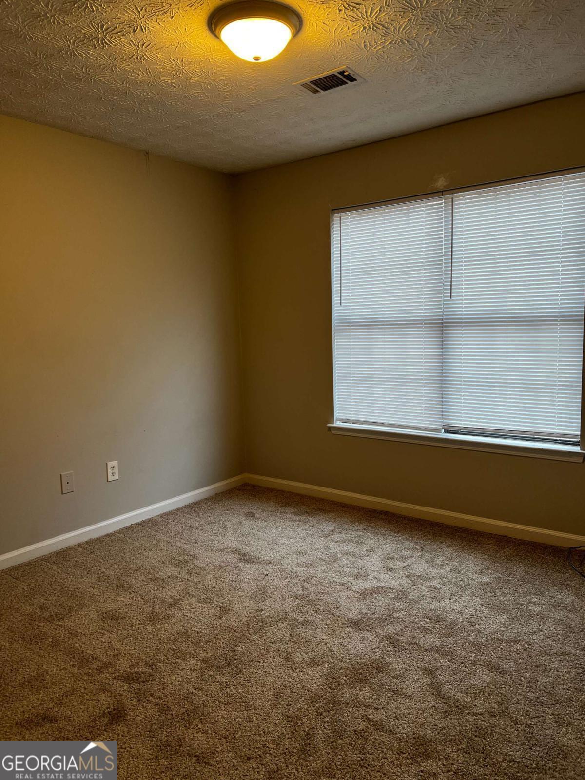 164 Adrian Drive Stockbridge, GA 30281 - Photo 9 of 12 an empty room with a window
