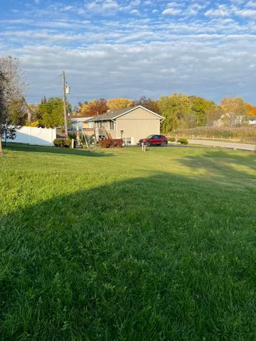 a view of yard with large trees