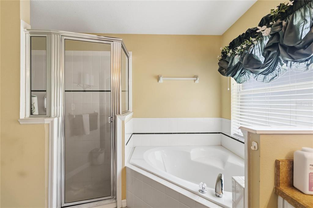 3225 Canoe Creek Road St. Cloud, FL 34772 - Photo 24 of 30 a bathroom with a bathtub and a shower