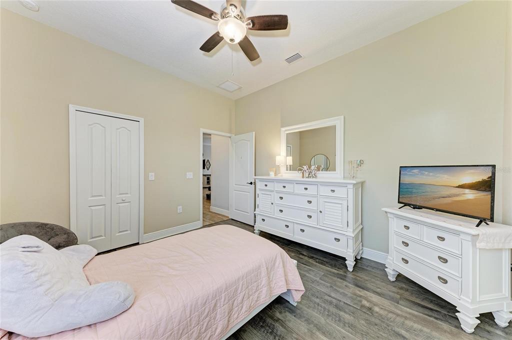 12642 Harney Street Venice, FL 34293 - Photo 32 of 85 a bedroom with a bed and wooden floor