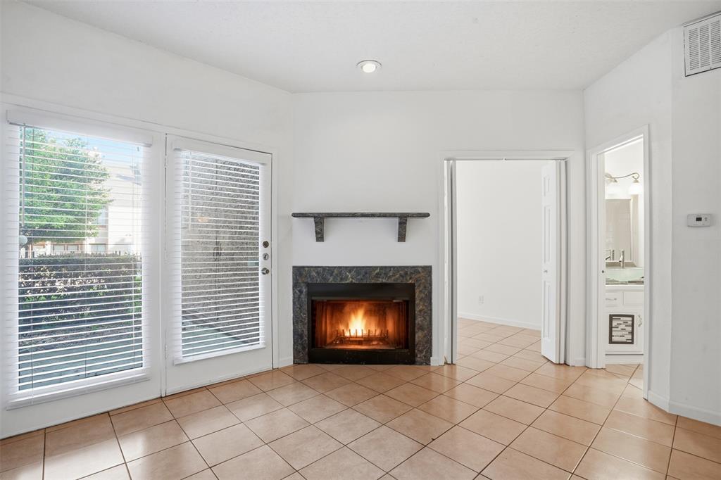 5550 Spring Valley Road, Unit F14 Dallas, TX 75254 - Photo 9 of 15 a living room with a fireplace