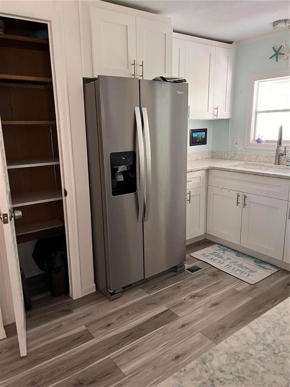 2295 North Beach Road, Unit 23 Englewood, FL 34223 - Photo 11 of 19 a kitchen with stainless steel appliances a refrigerator and cabinets