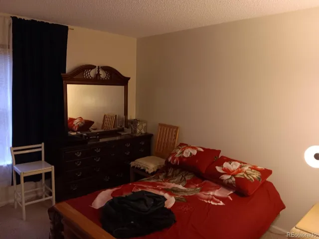 a bed room with a bed and a mirror